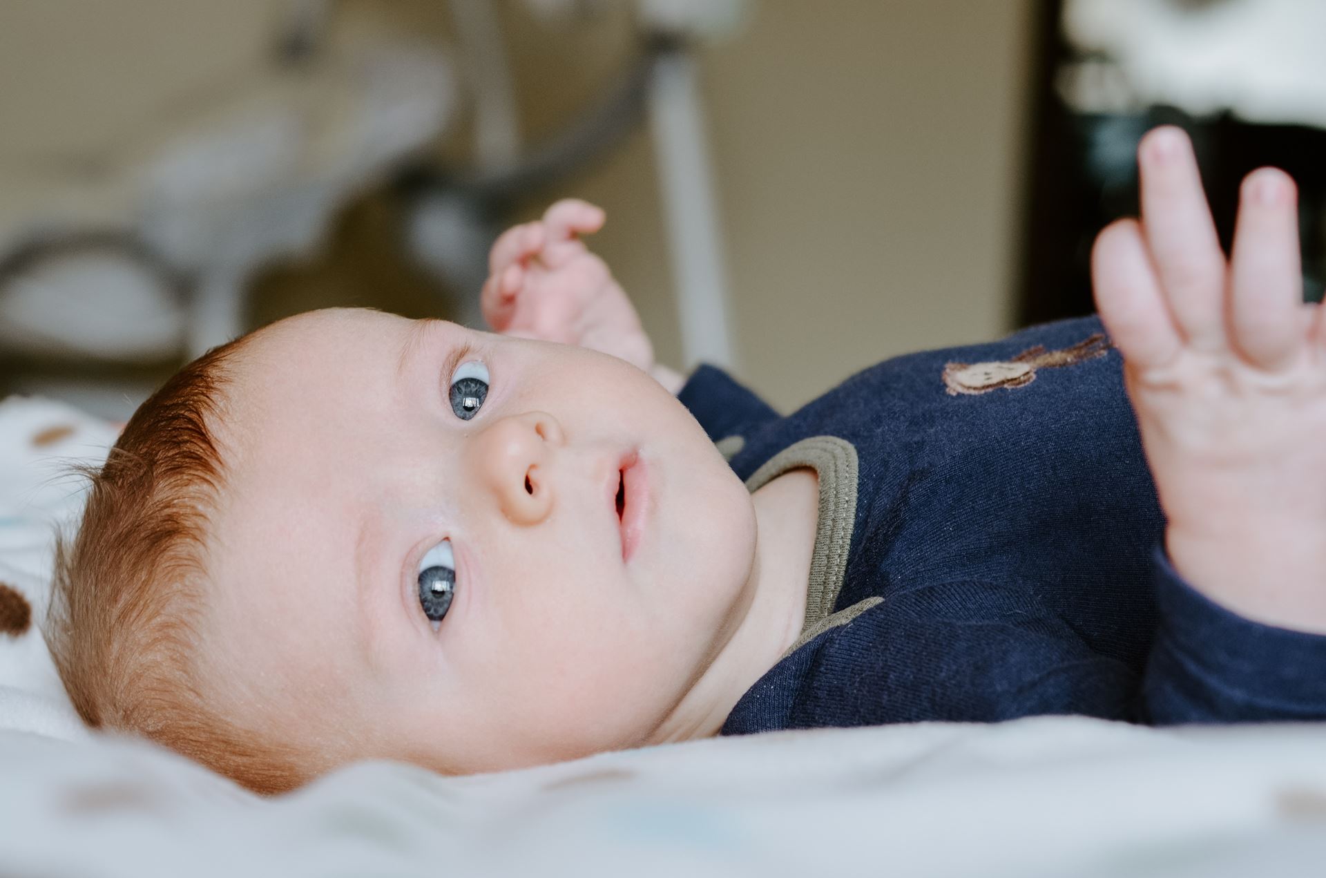 a baby lying on a bed